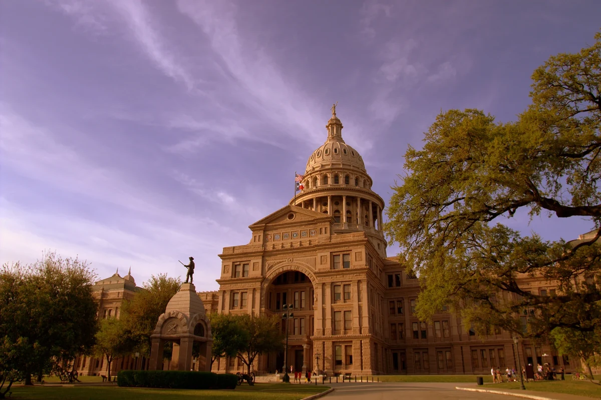 The Texas State Capitol in Austin framed by trees